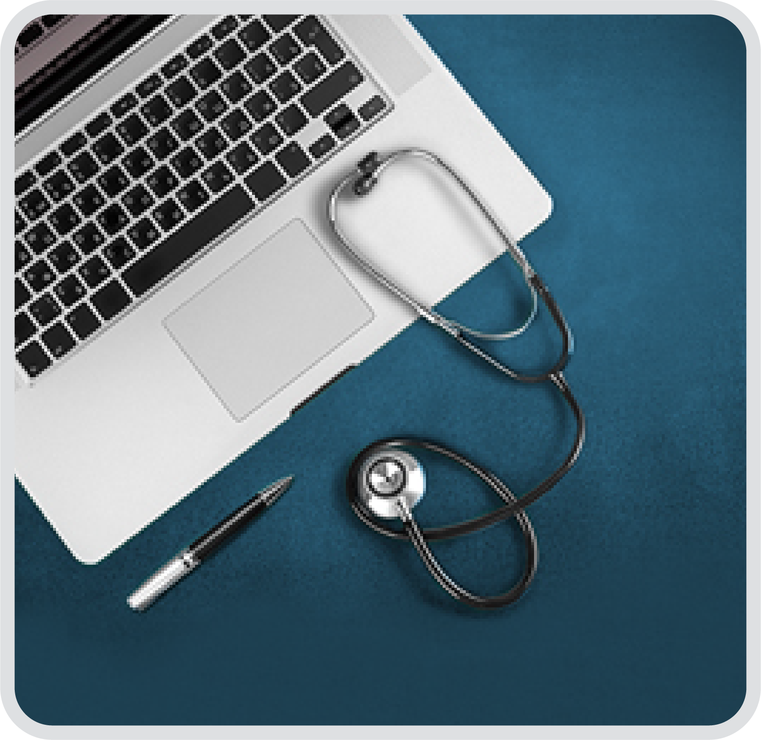 Overhead shot of a open laptop, stethoscope and pen.